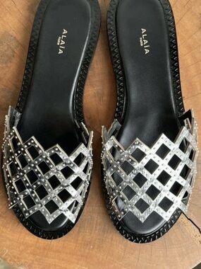 Alaïa Black Leather Slides with Silver Studded Lattice